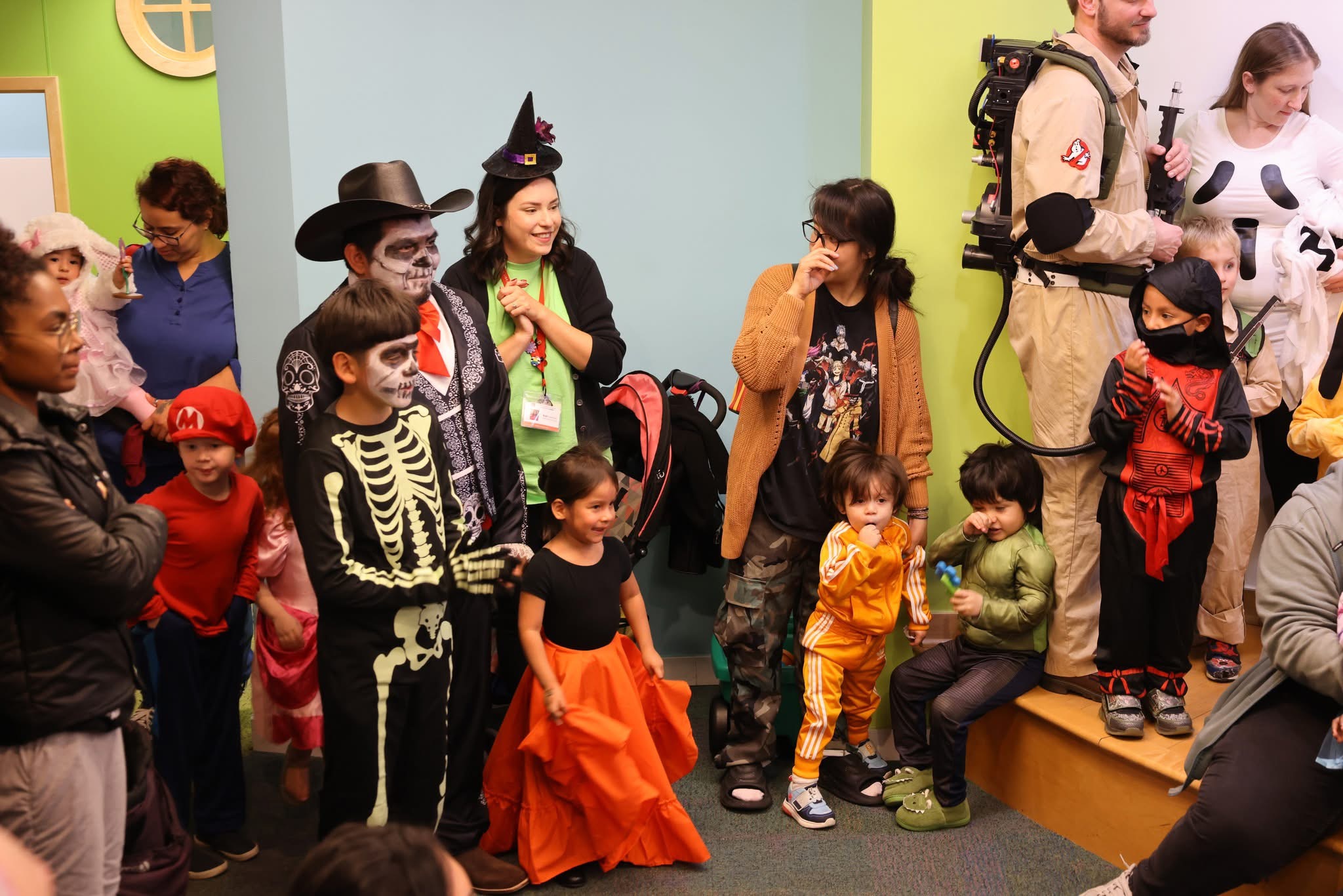 Rubi smiling with children and families at a library program