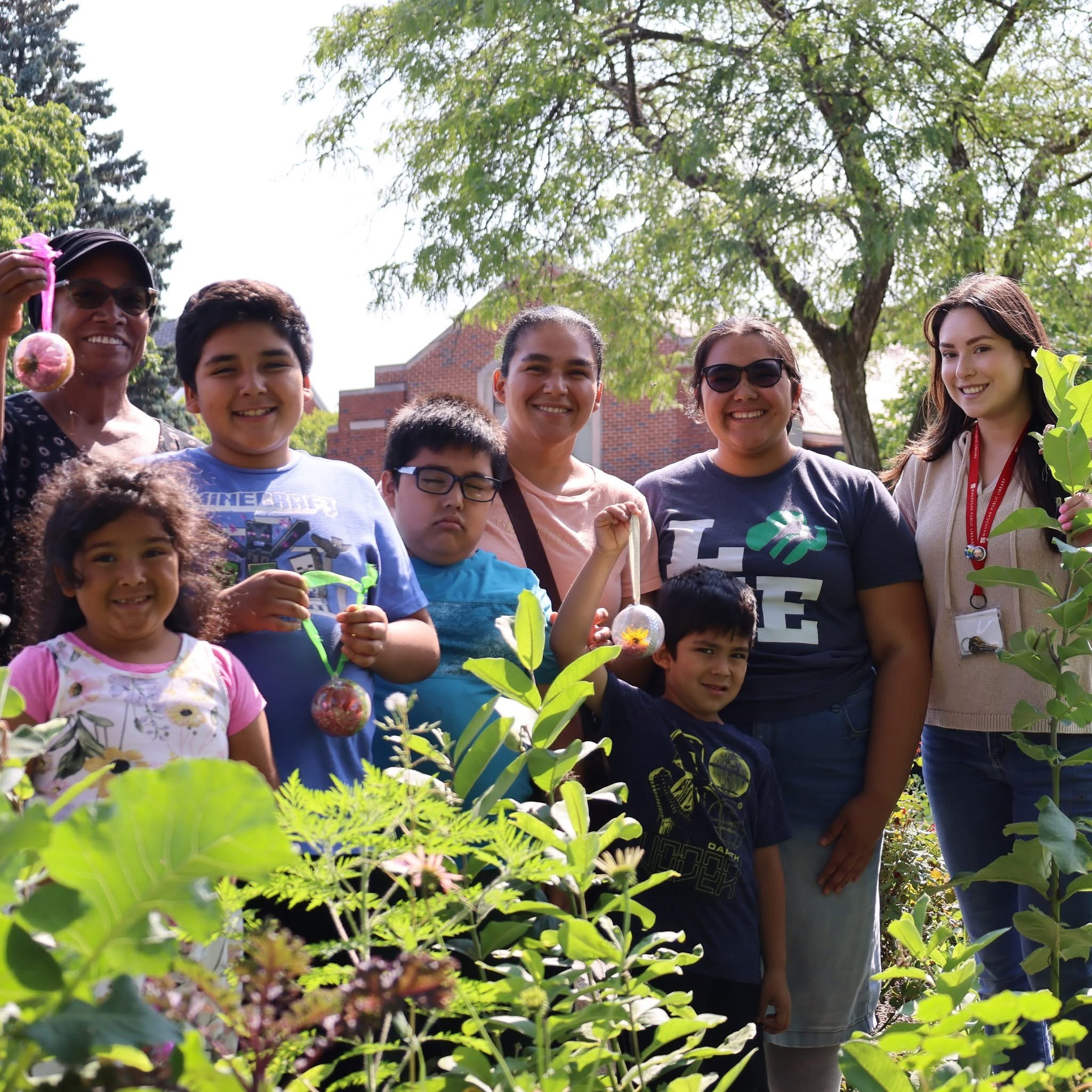 Rubi with children and families in an outdoor garden activity